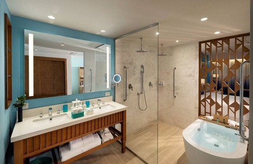 Punta Cana Hotel | Elegant Art Suite: Freestanding Tub, Rainforest Showers, and Premium Benefits