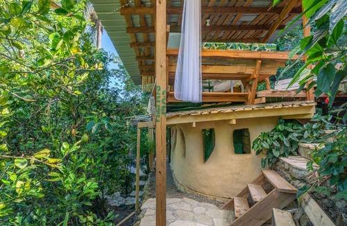 Jarabacoa Cottage | Rustic earthen two story cottage in Quintas del Bosque sleeps two couples.