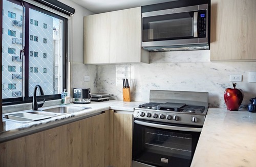 Ensanche Quisqueya Apartment | Spacious 3-bedroom apartment with AC in peaceful Santo Domingo, Pool and Gym