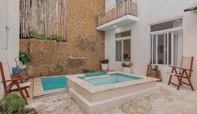 Enriquillo 2-bdrm apt with ensuite baths, full kitchen, and cozy living room.