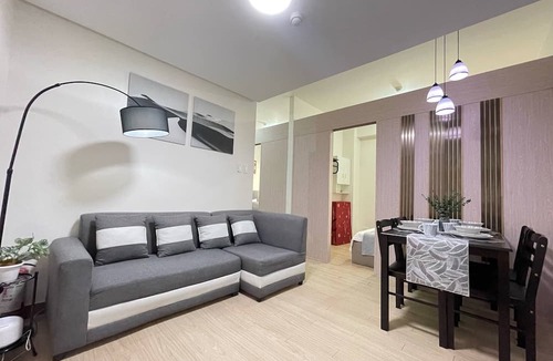 Novaliches Condo | Spacious Comfort: Two bedrooms & large living space ideal for families friends